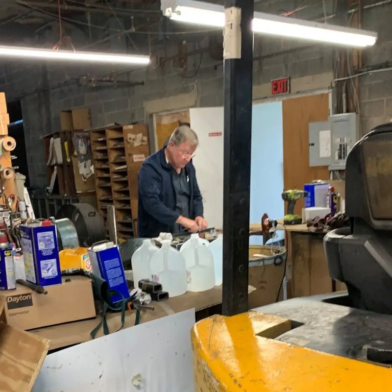 Person working in a workshop with equipment.